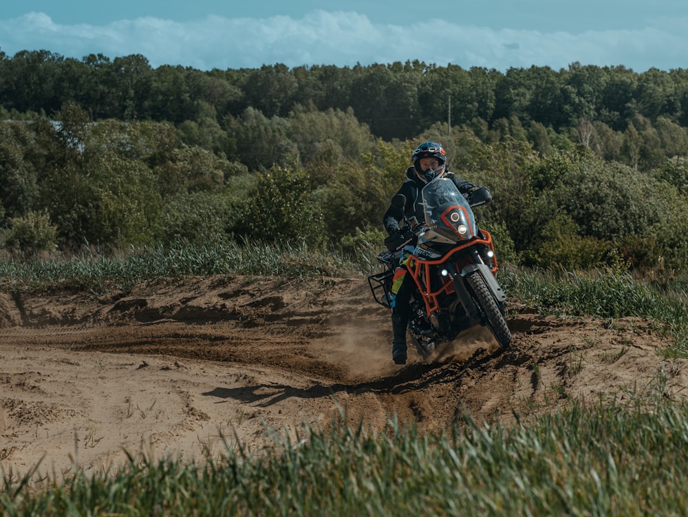 a man riding a dirt bike on a dirt road