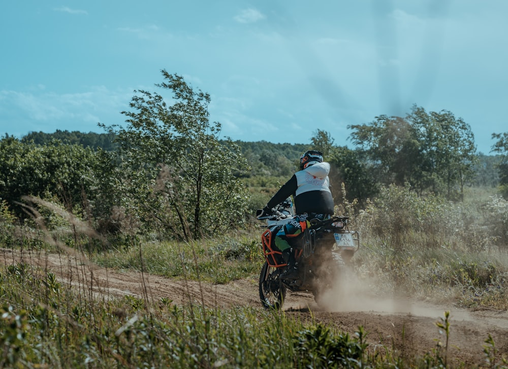 a person riding a dirt bike on a dirt road