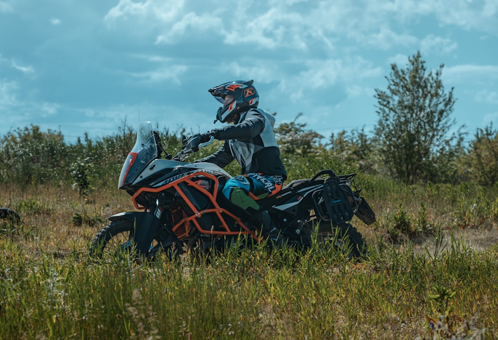 a person riding a motorcycle in a field