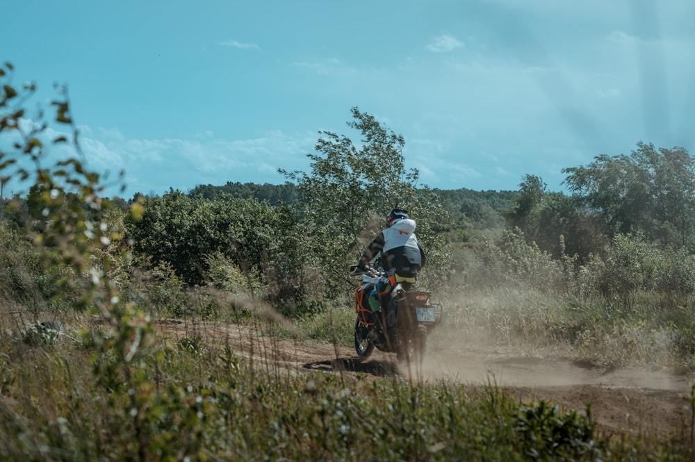 a person riding a dirt bike on a dirt road