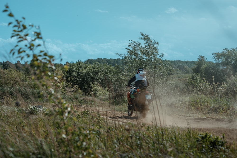 a person riding a dirt bike on a dirt road