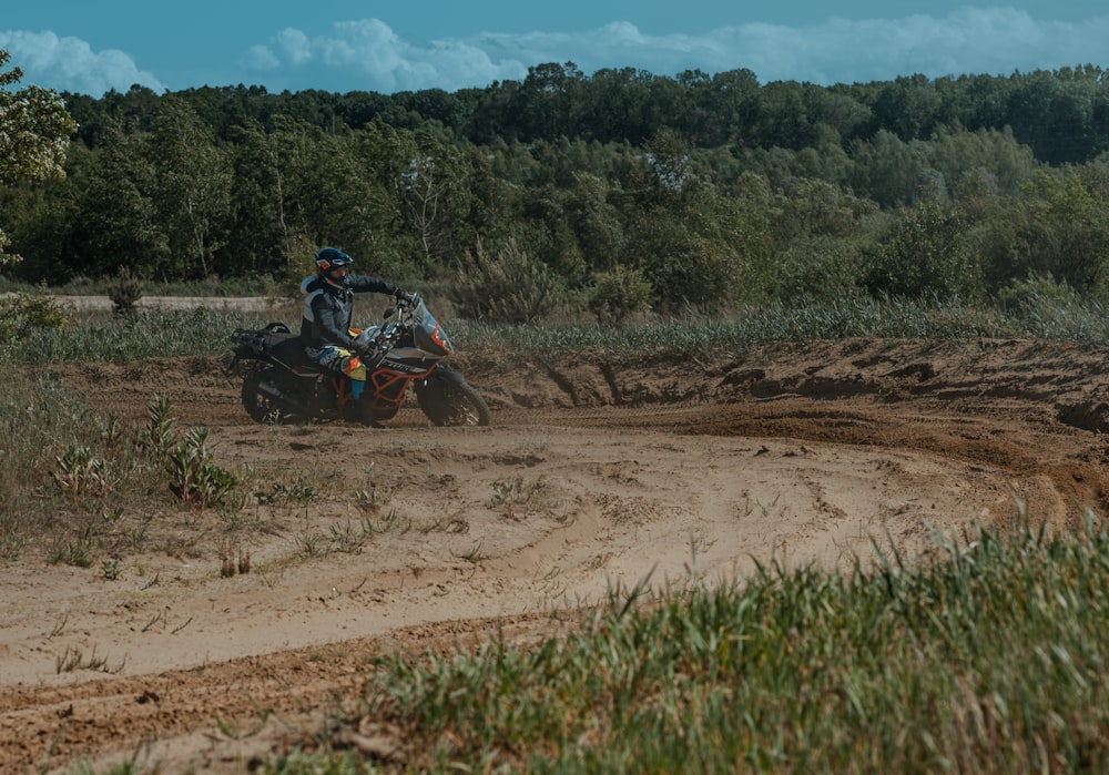 a person riding a dirt bike on a dirt road