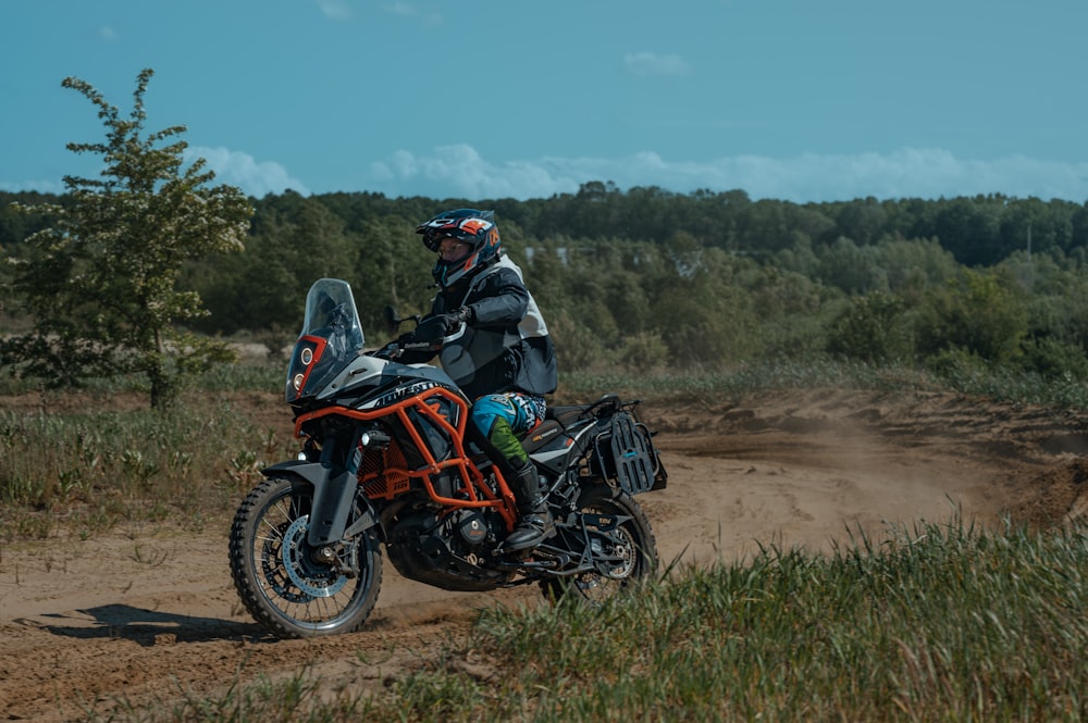 a person riding a motorcycle on a dirt road