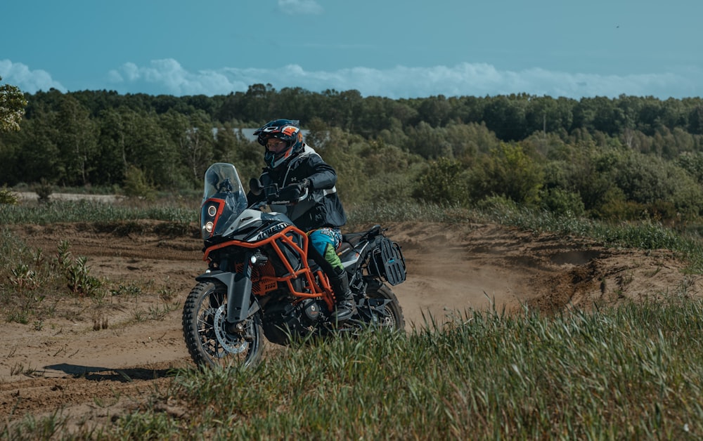 a person riding a motorcycle on a dirt road