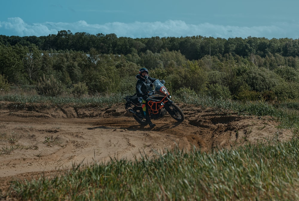 a man riding a dirt bike on a dirt road