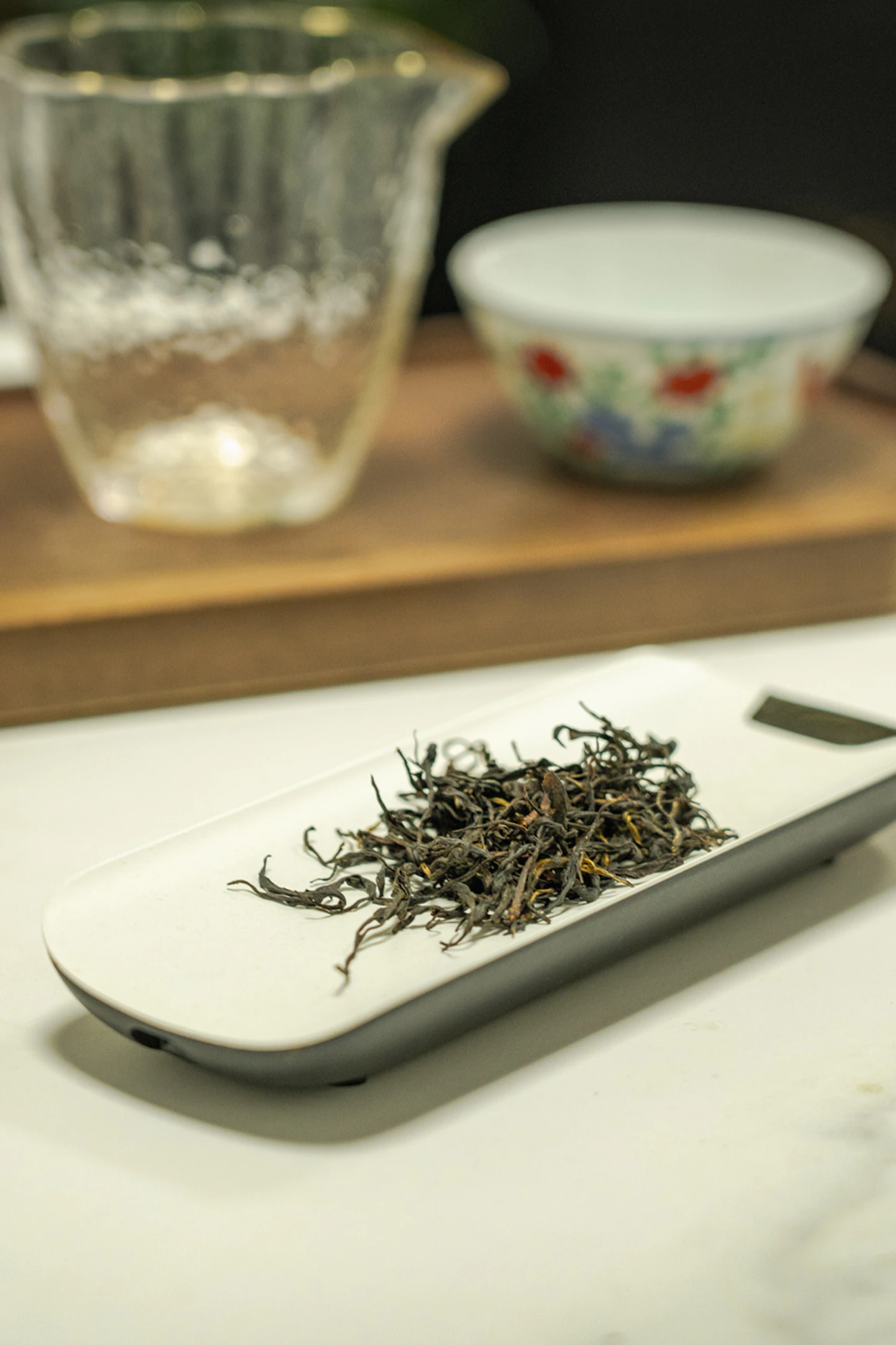 Flat green needles of Shincha Yabukita weighed out on a scale platter, sold out until March