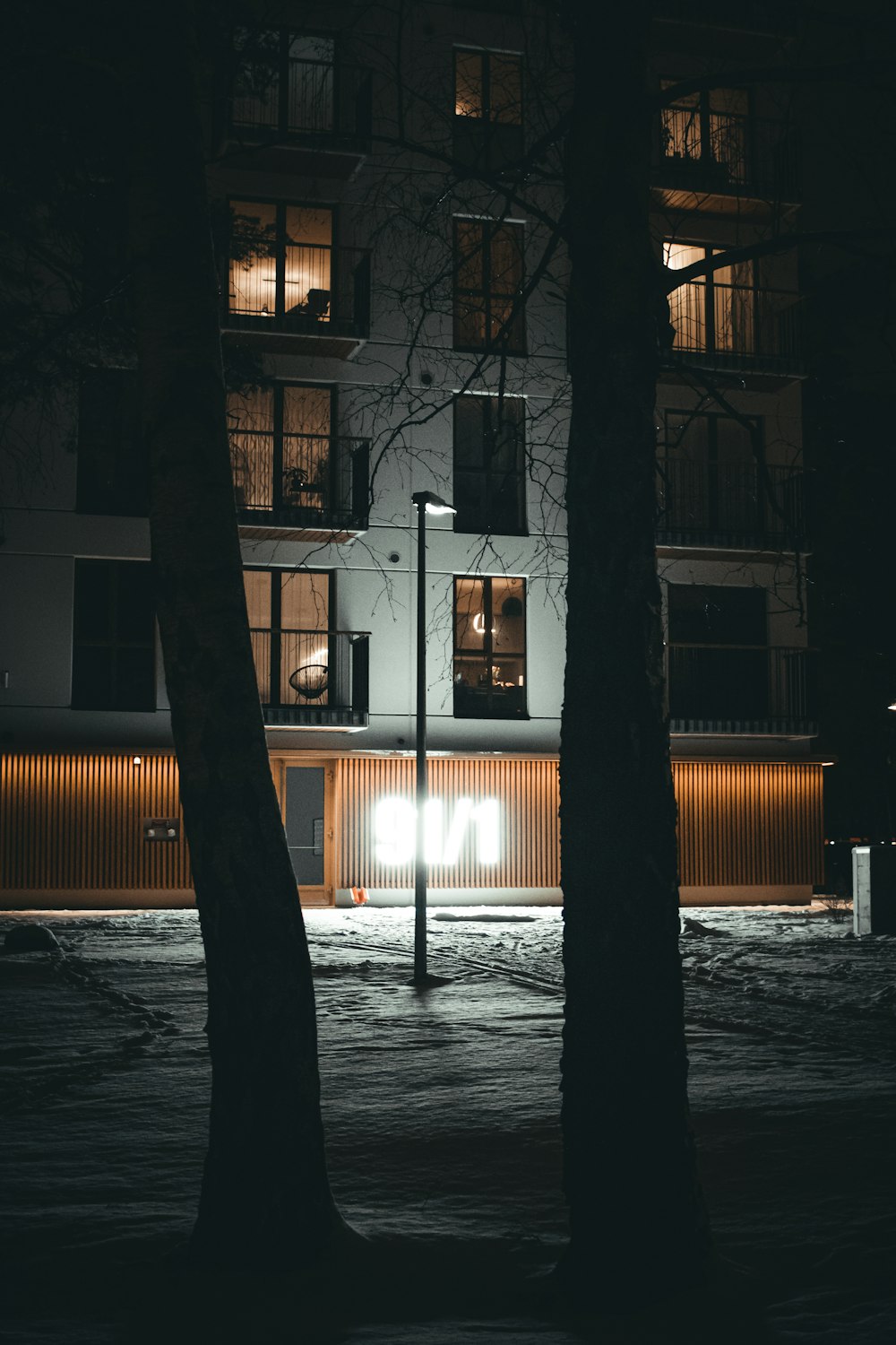 a street light in front of a building at night