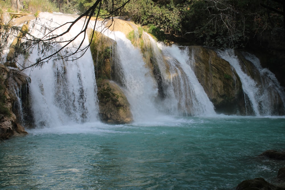 a large waterfall with water cascading down it's sides