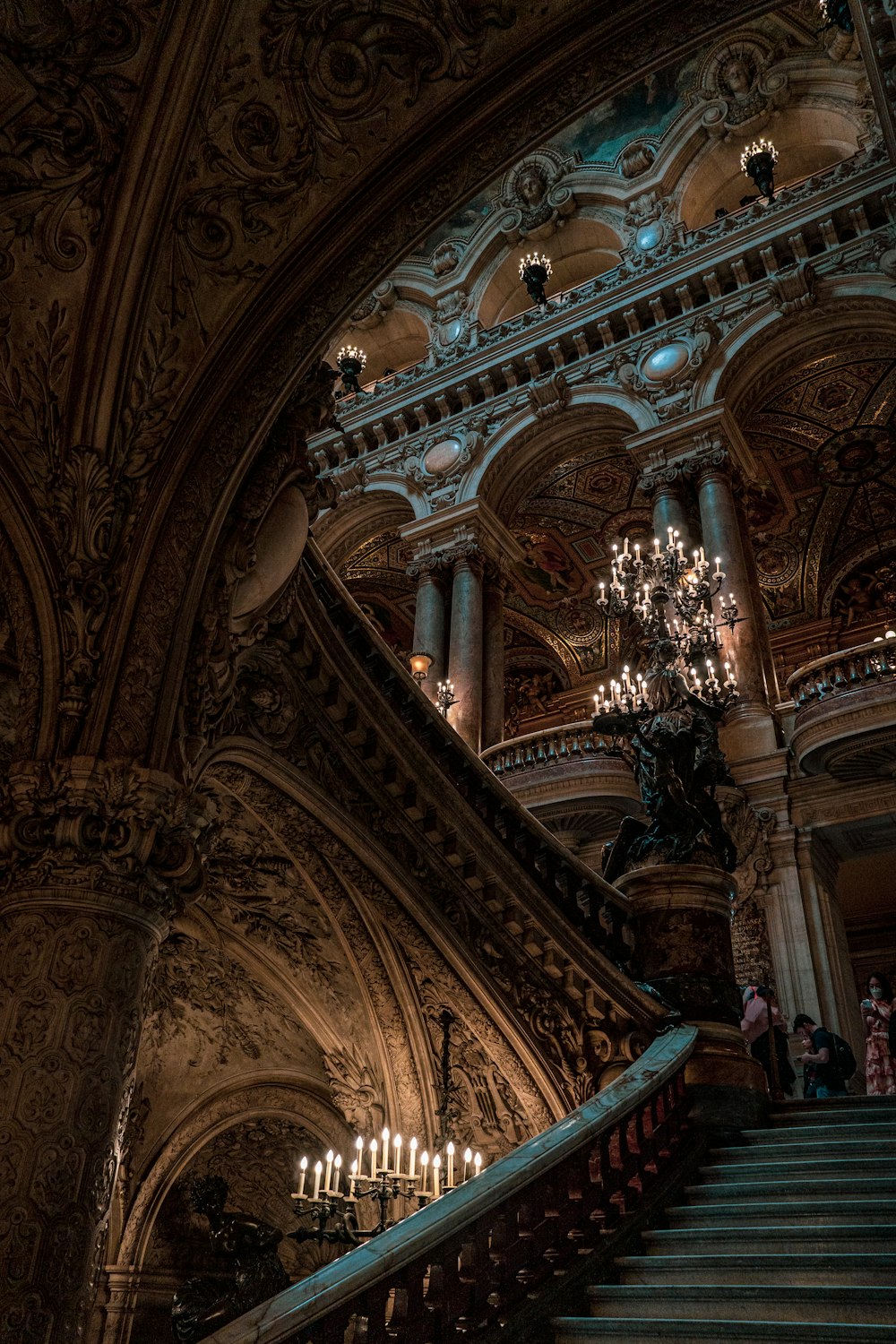 a staircase with chandeliers and chandeliers in a building