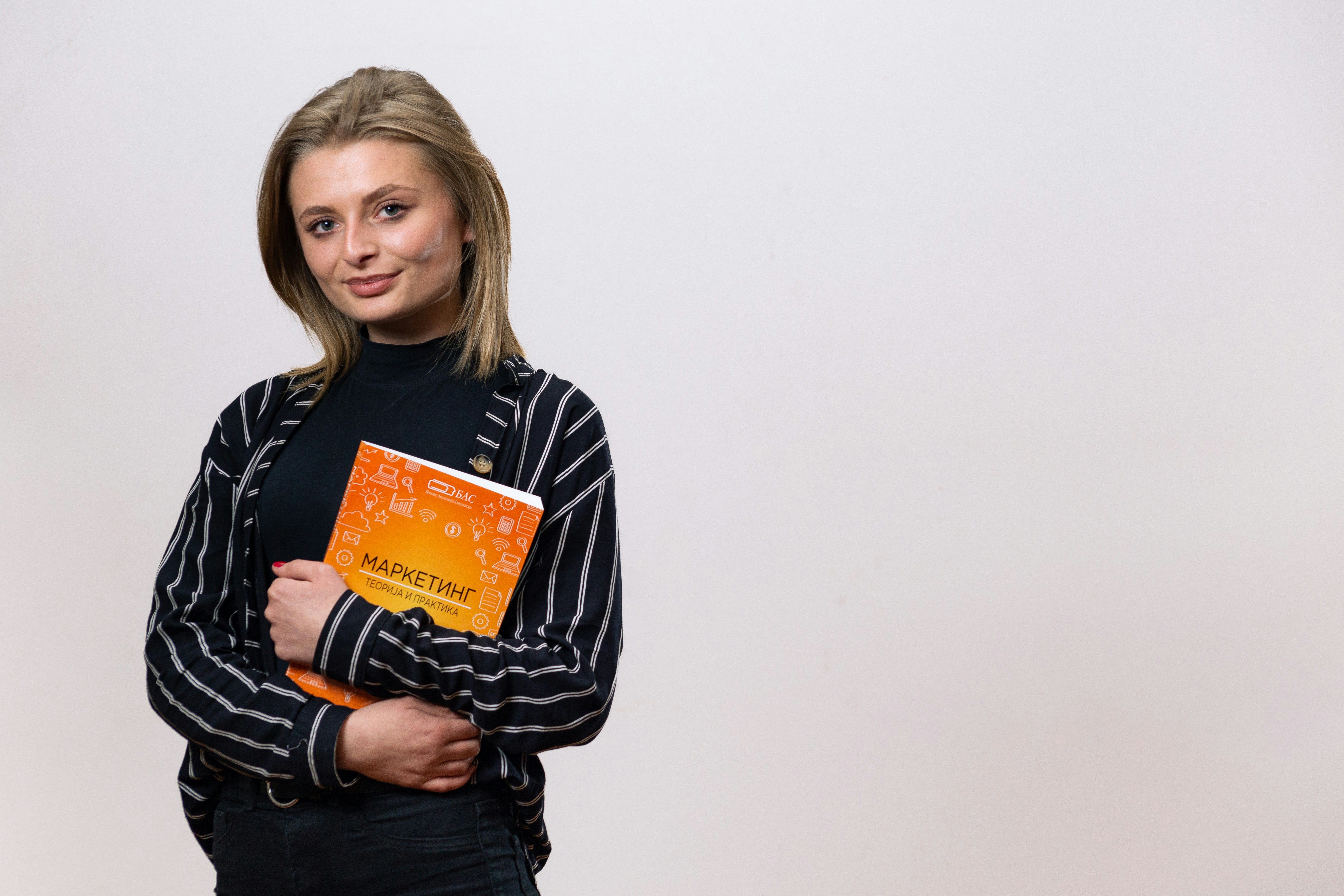 a woman is holding a book in her hands