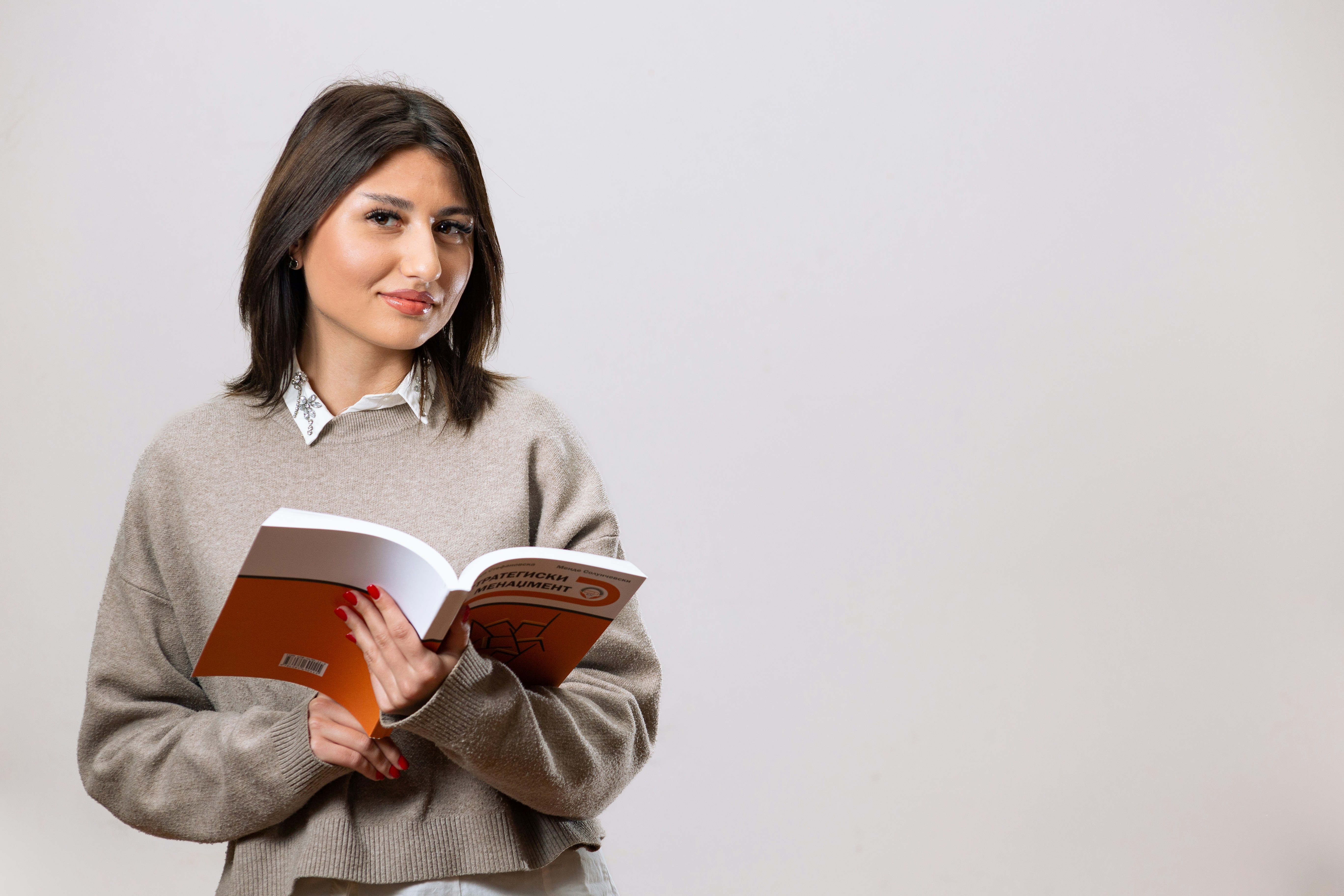 a woman is holding a book in her hands