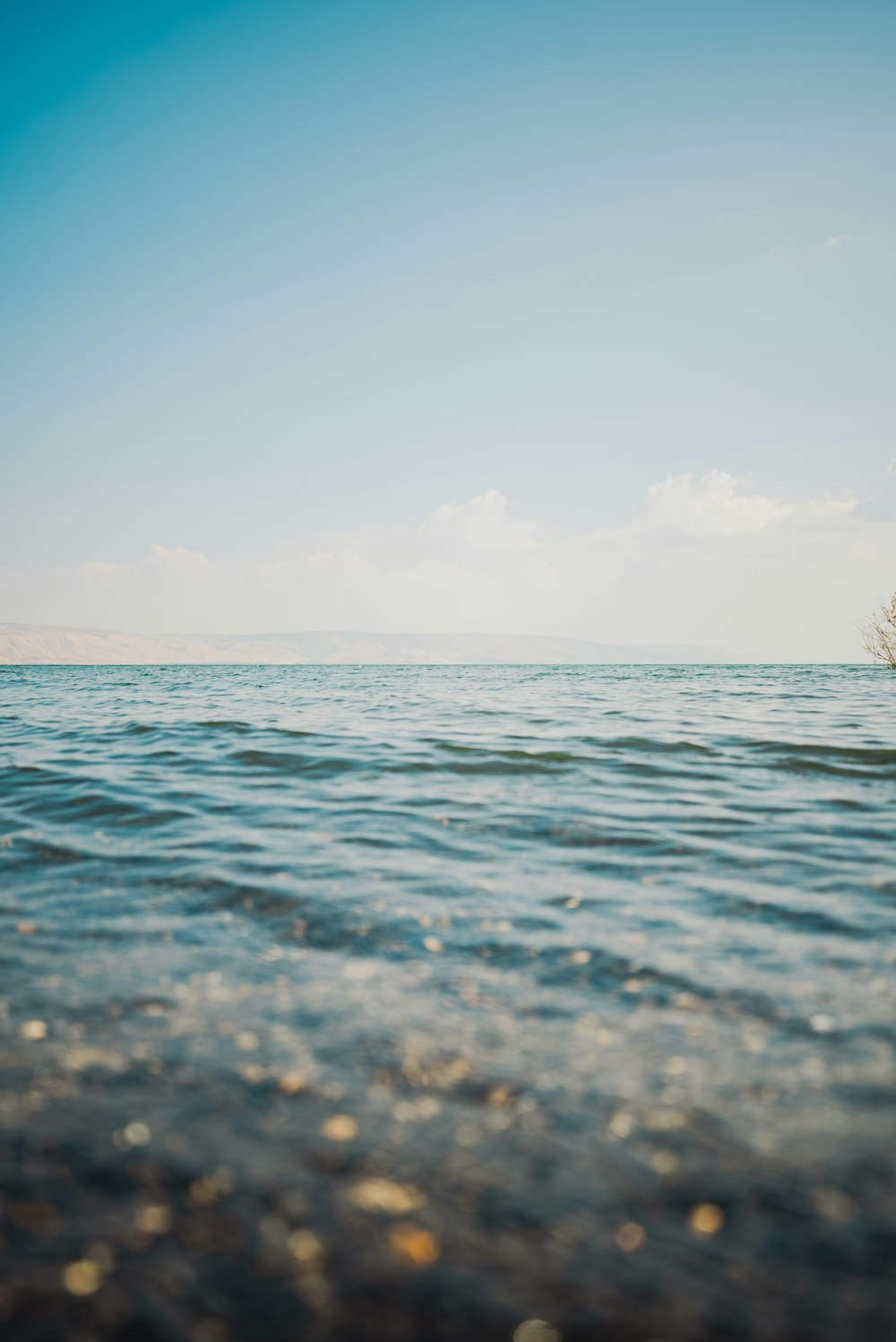 a body of water with a boat in the distance