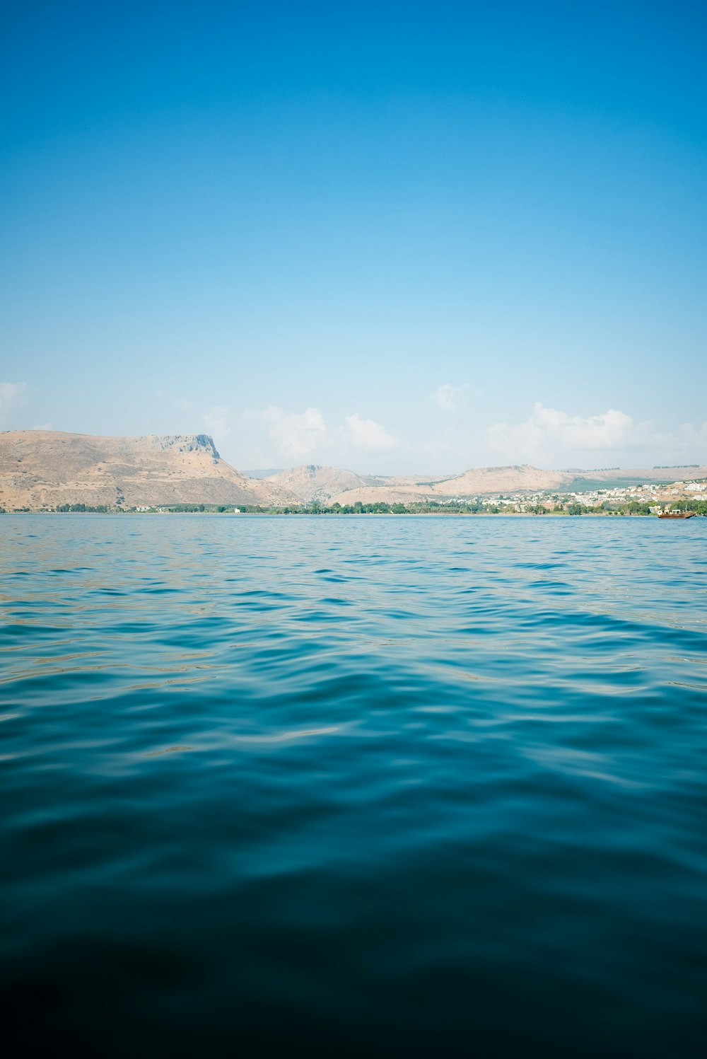 a body of water with mountains in the background