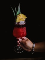 A colorful sorrel cocktail served with tropical fruits.