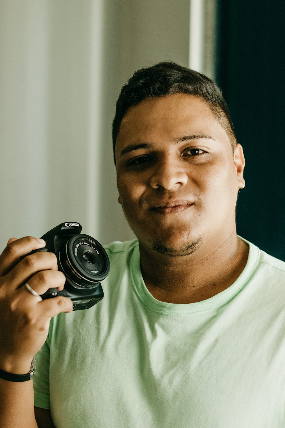 a man holding a camera up to his face