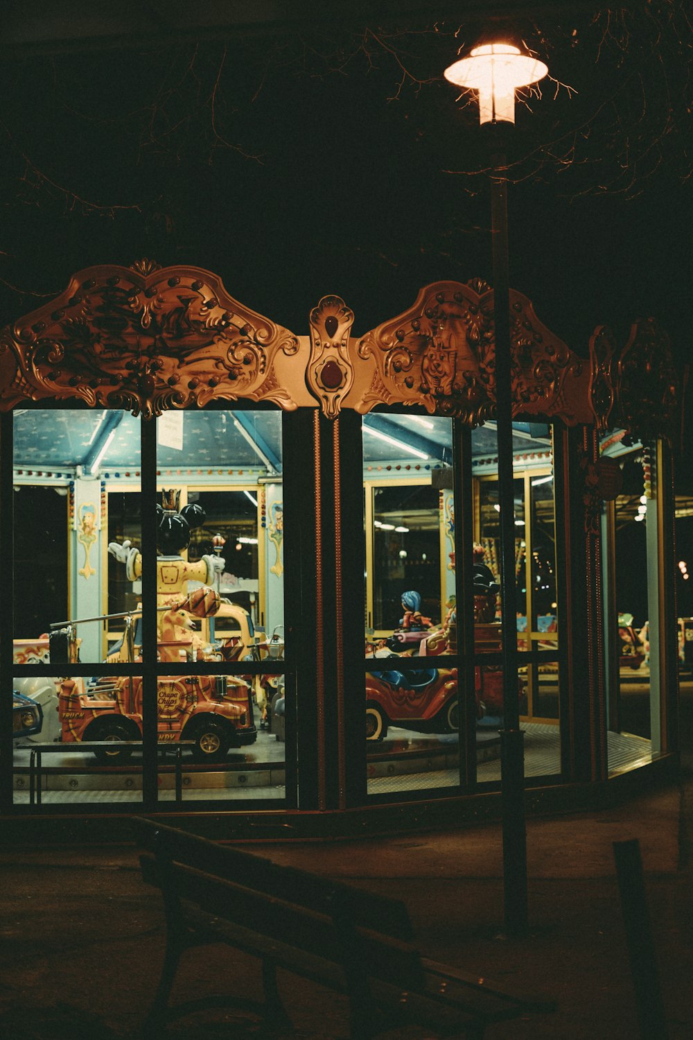 a bench sitting in front of a building at night