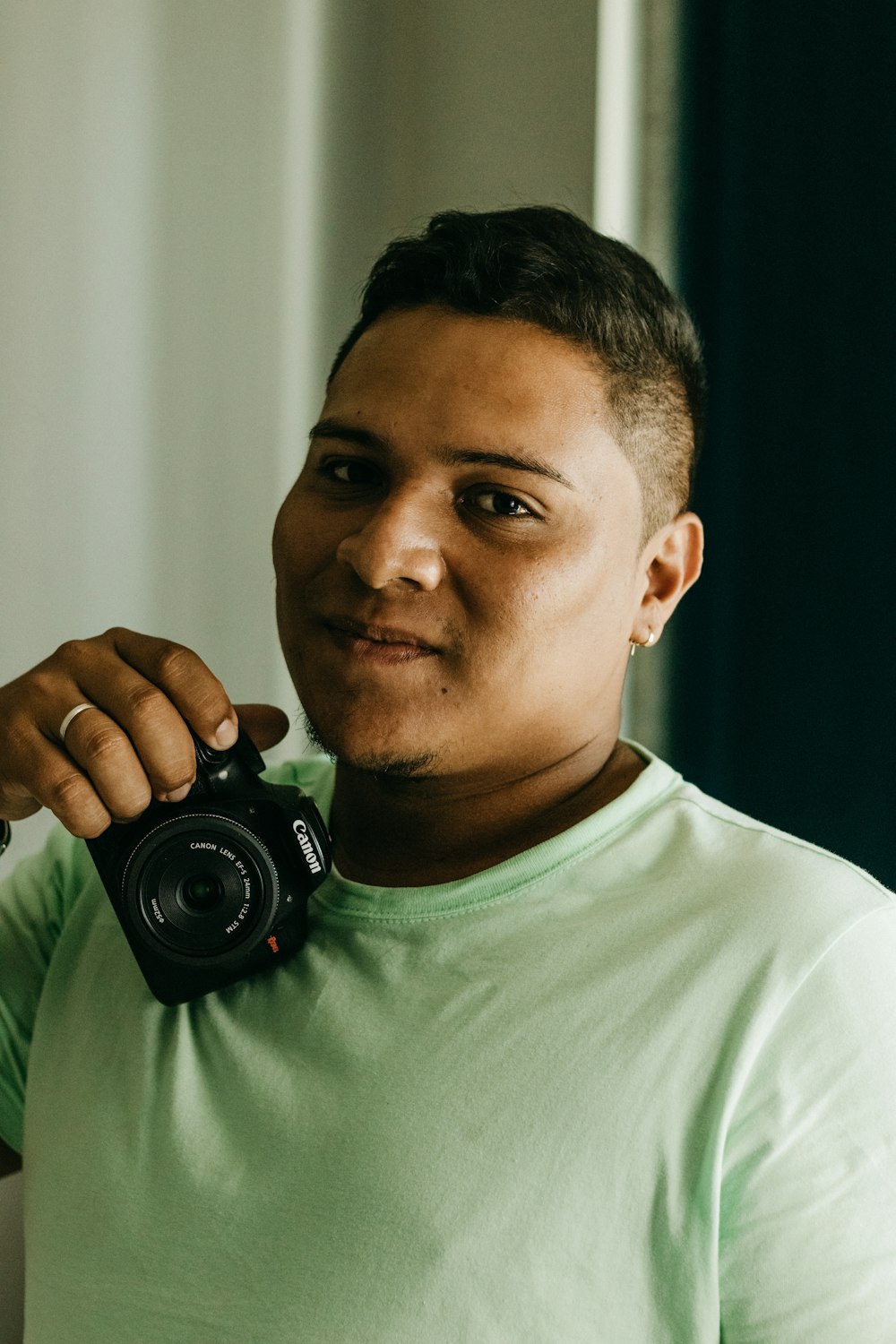 a man holding a camera up to his face