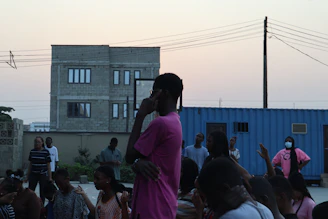 A community gathering around the container during an evening mental health support session.