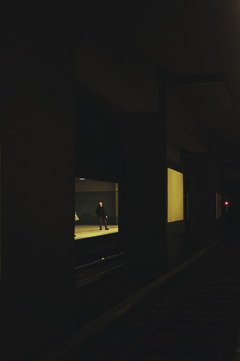 a person walking down a dark hallway at night