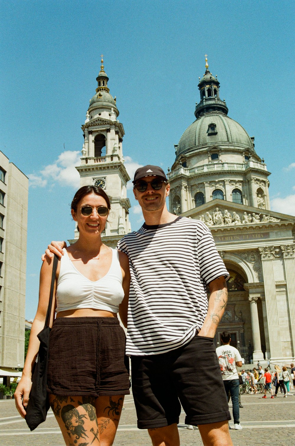 a man and a woman standing in front of a building