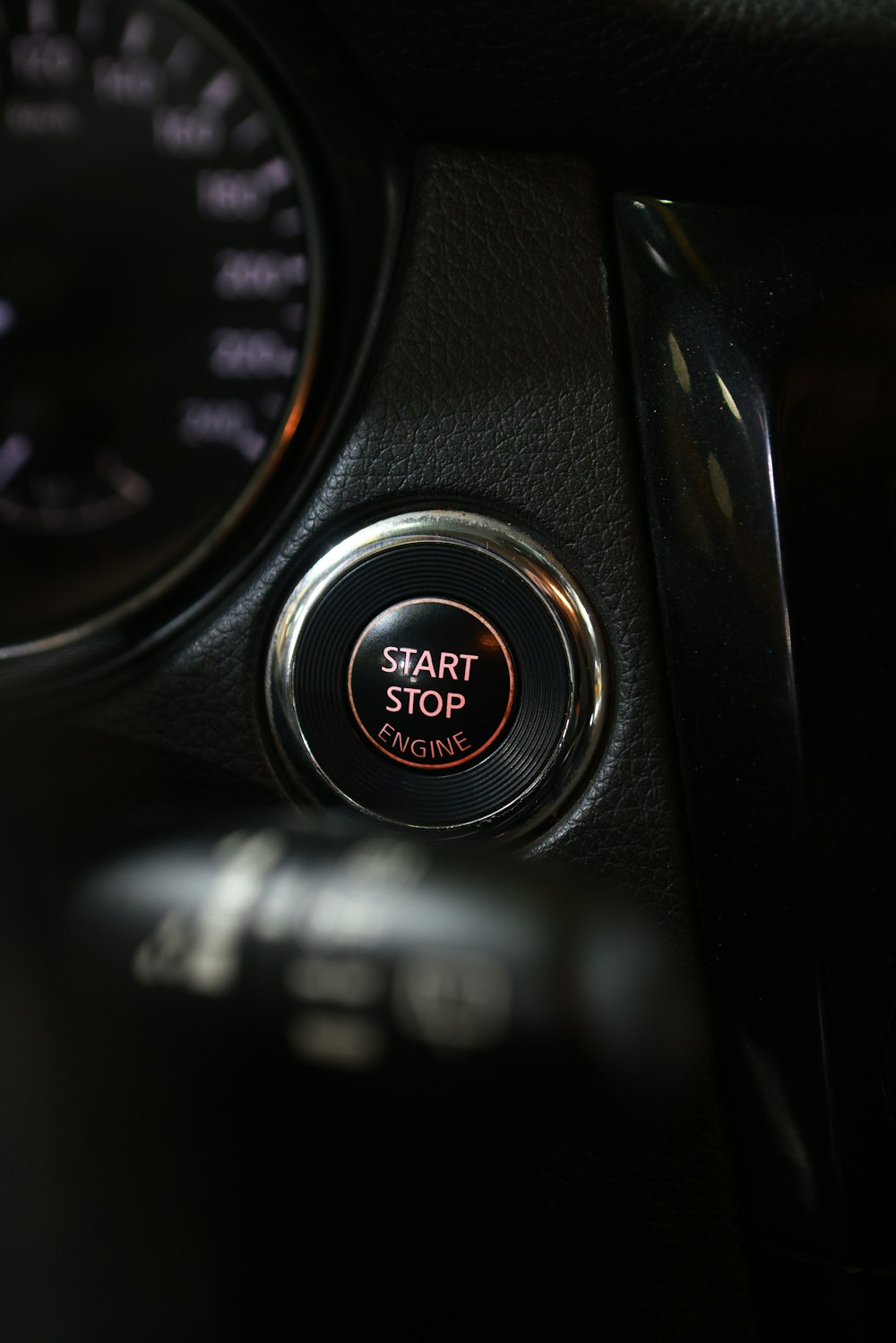 the start button of a car with a speedometer