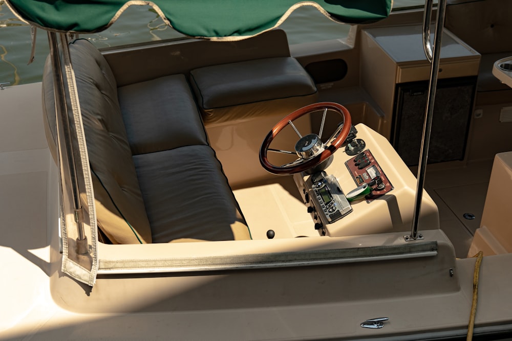 a boat with a steering wheel and a seat