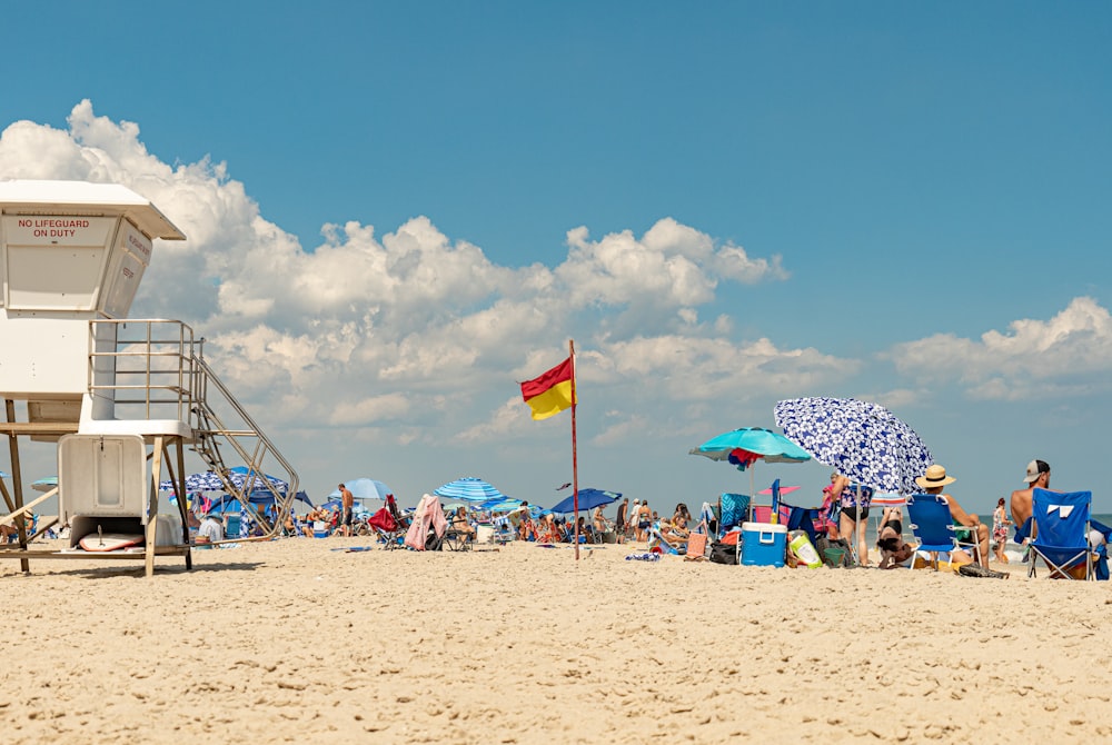 a group of people on a beach with umbrellas