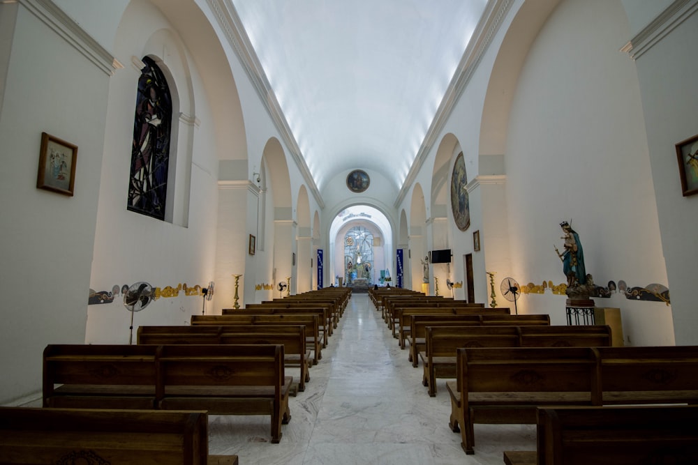 a church filled with wooden pews and stained glass windows