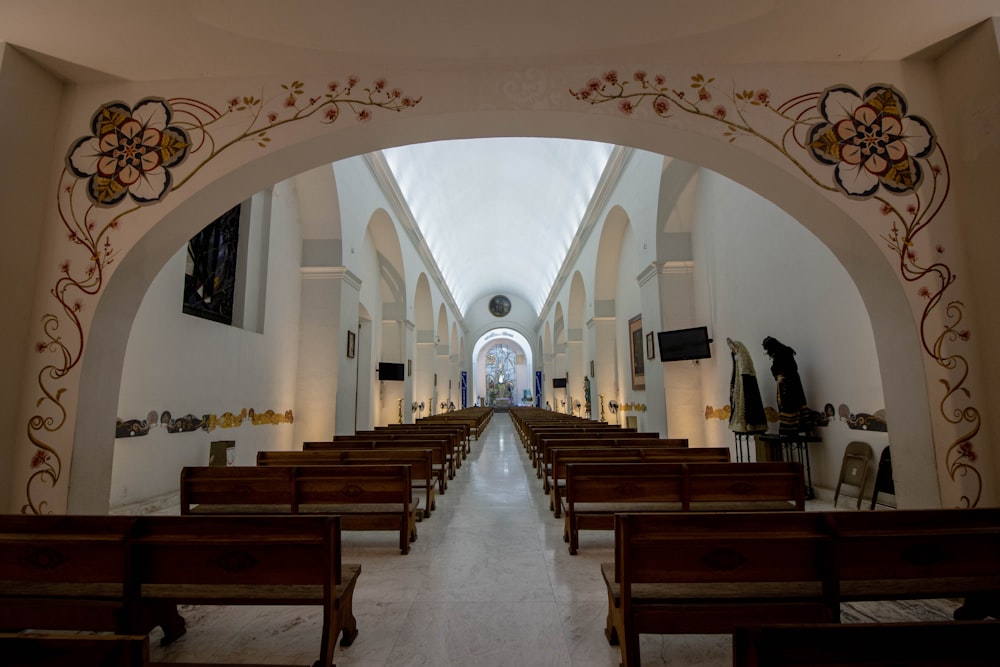 a church filled with wooden pews and stained glass windows