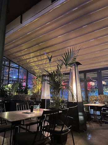 Cozy indoor seating area of Triple S Craft BBQ, glowing with warm lighting.