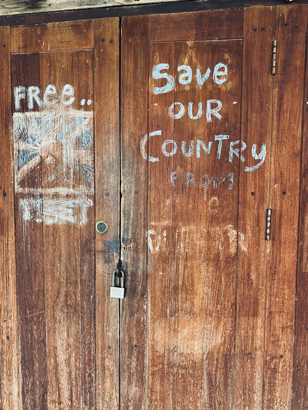 a couple of wooden doors with graffiti on them