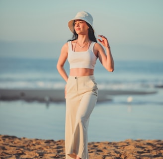 a woman standing on top of a sandy beach