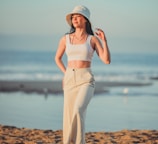 a woman standing on top of a sandy beach