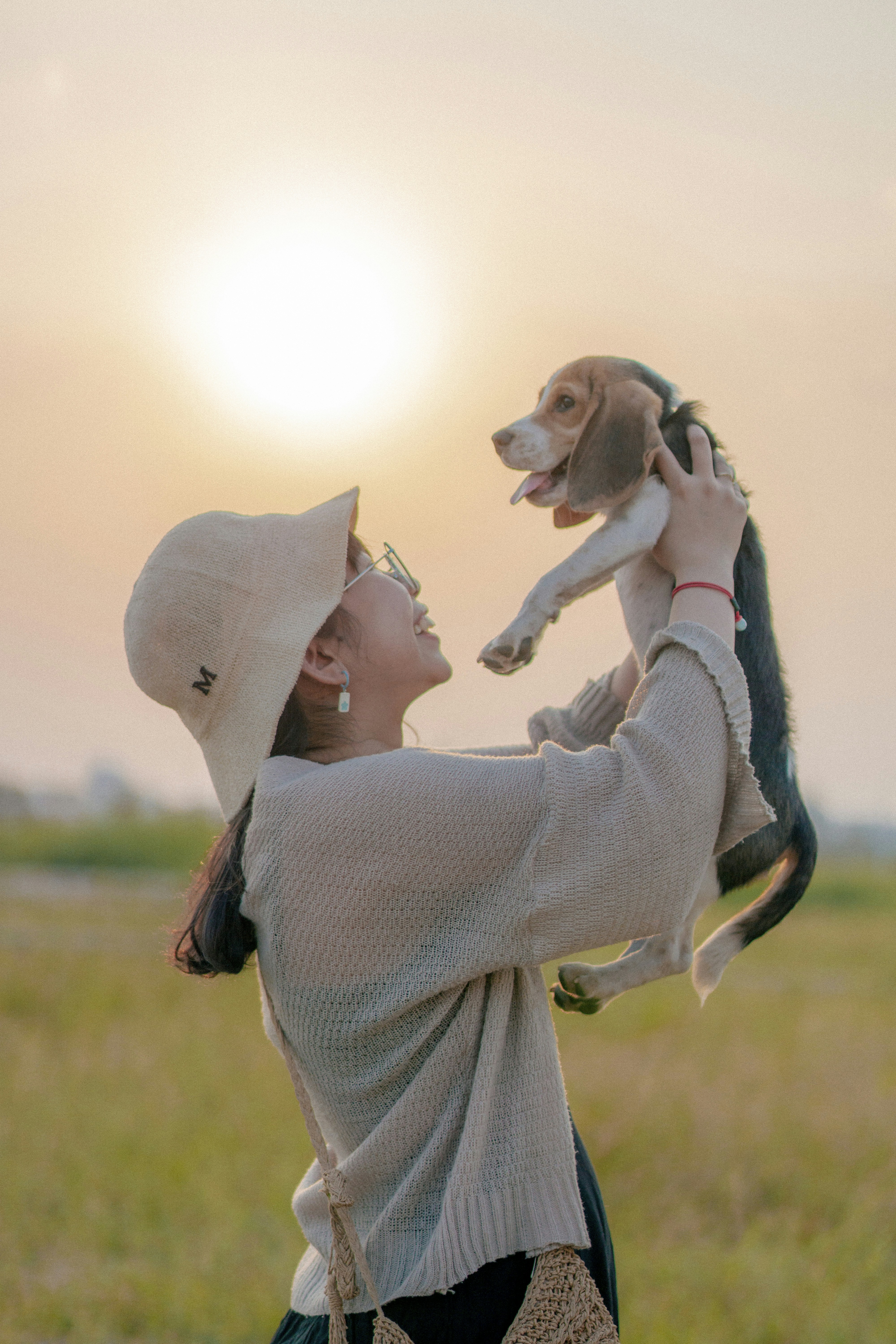 a woman holding a small dog up to her face