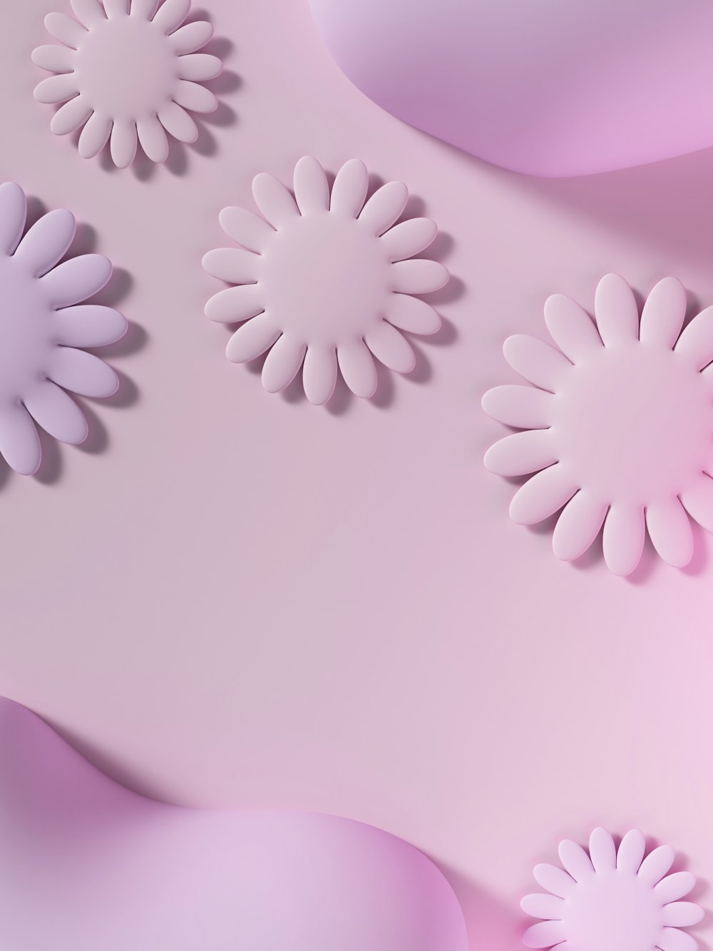 a close up of paper flowers on a pink background
