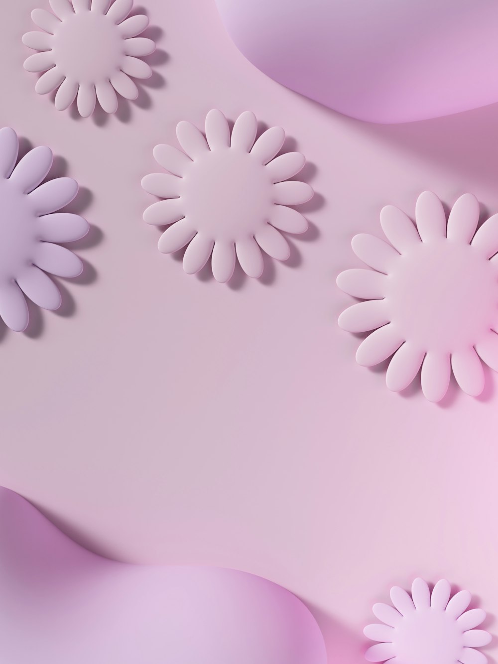 Un primer plano de flores de papel sobre un fondo rosa