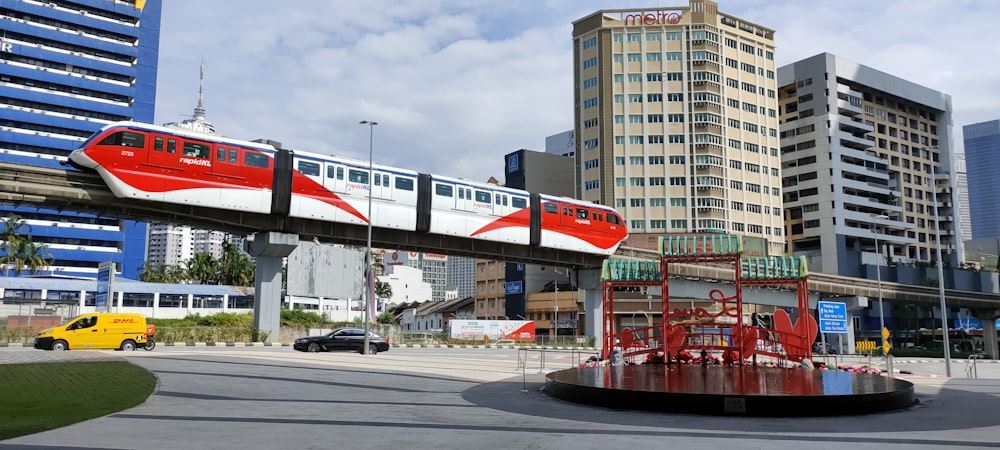 a red and white train traveling over a bridge