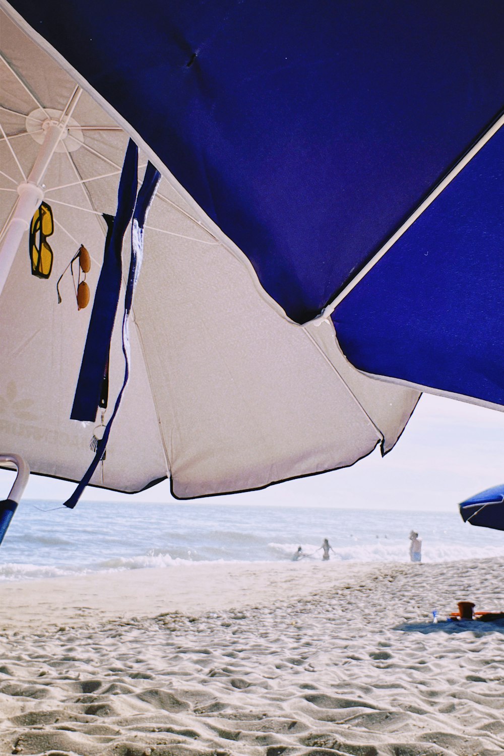 a group of umbrellas sitting on top of a sandy beach