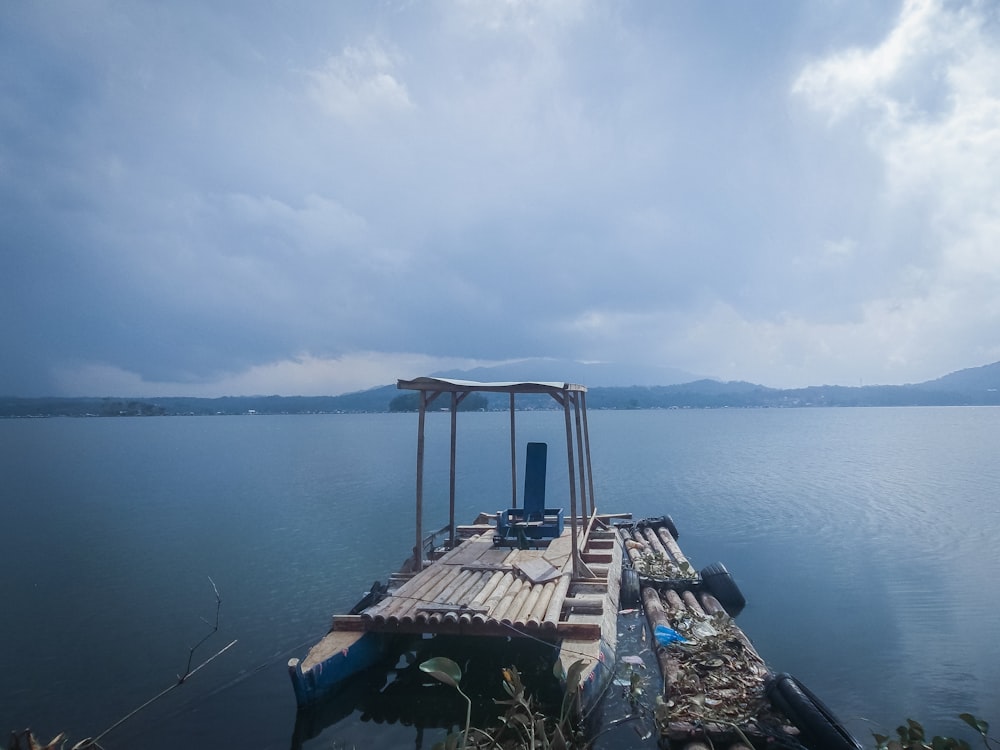 a dock on a lake with a chair on it