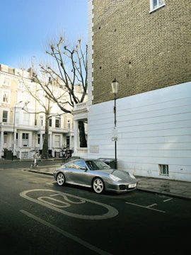 A shiny used car parked on a quiet street in a residential area