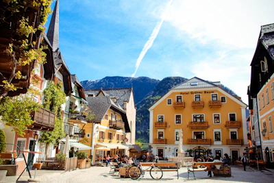 A quaint village square with bicycles parked near a café bustling with locals.