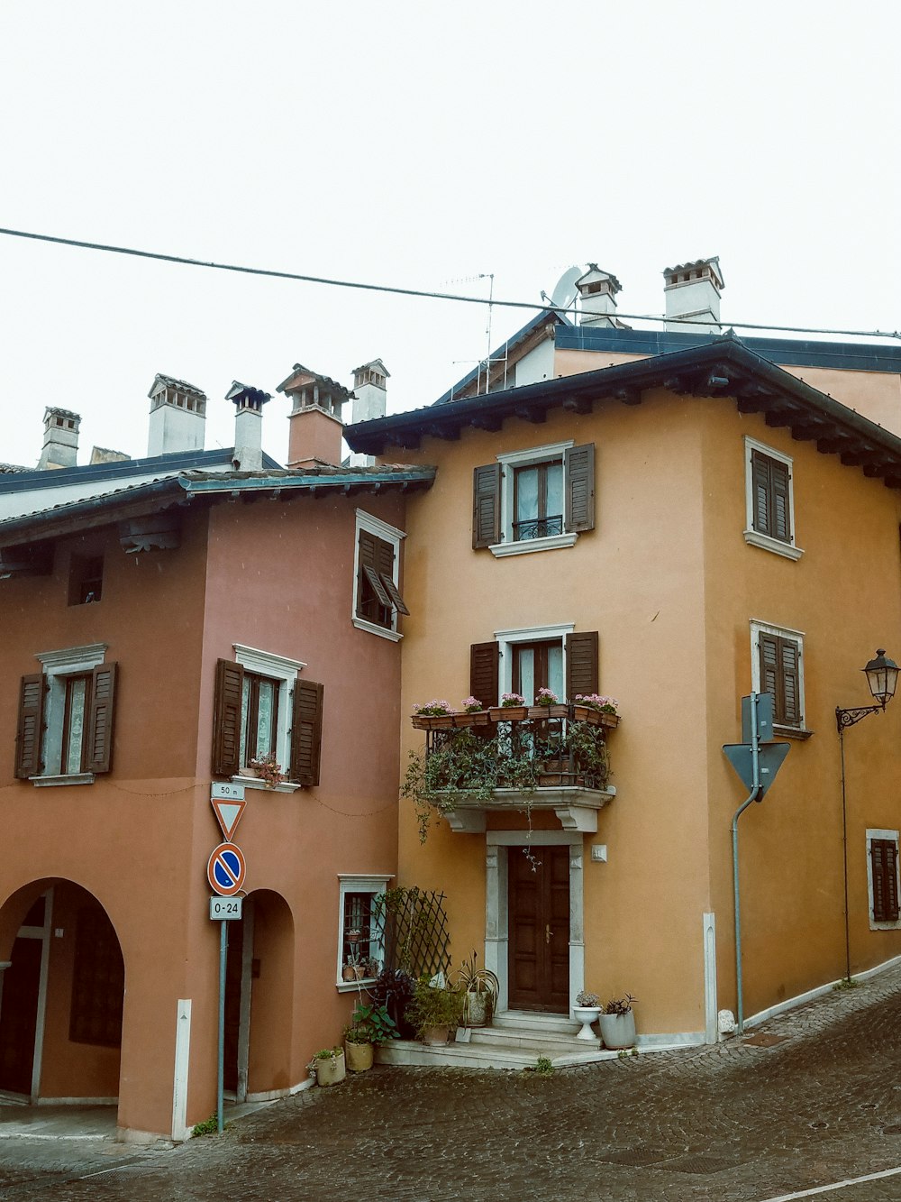 a row of multi - colored houses with a street sign in front of them