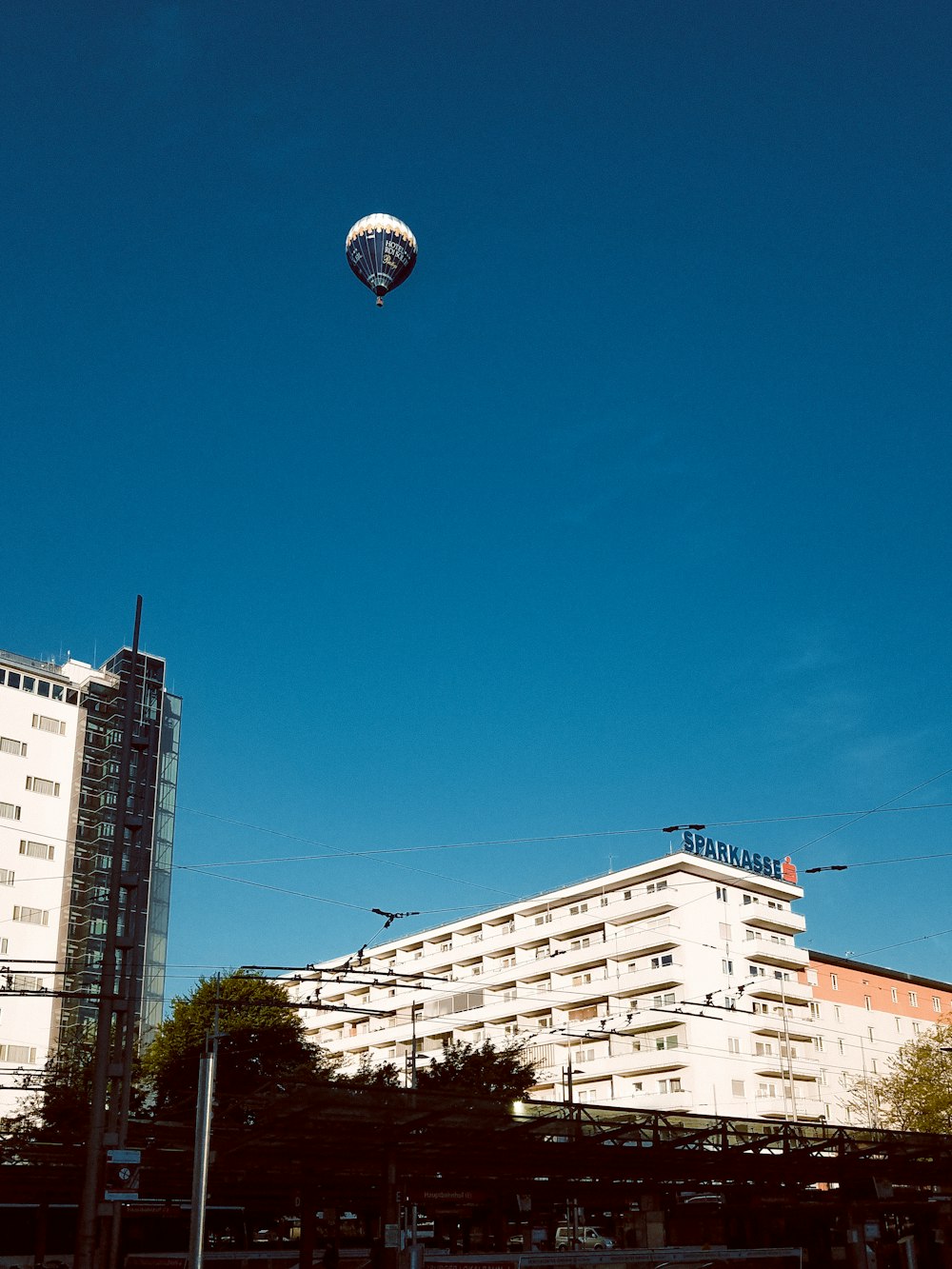 a hot air balloon flying over a city