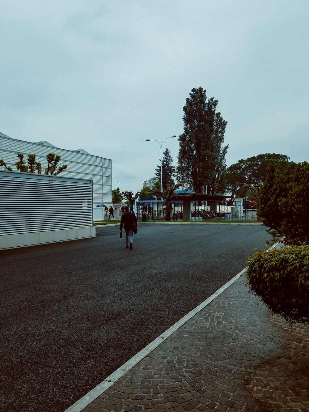 a person walking down a street in the rain