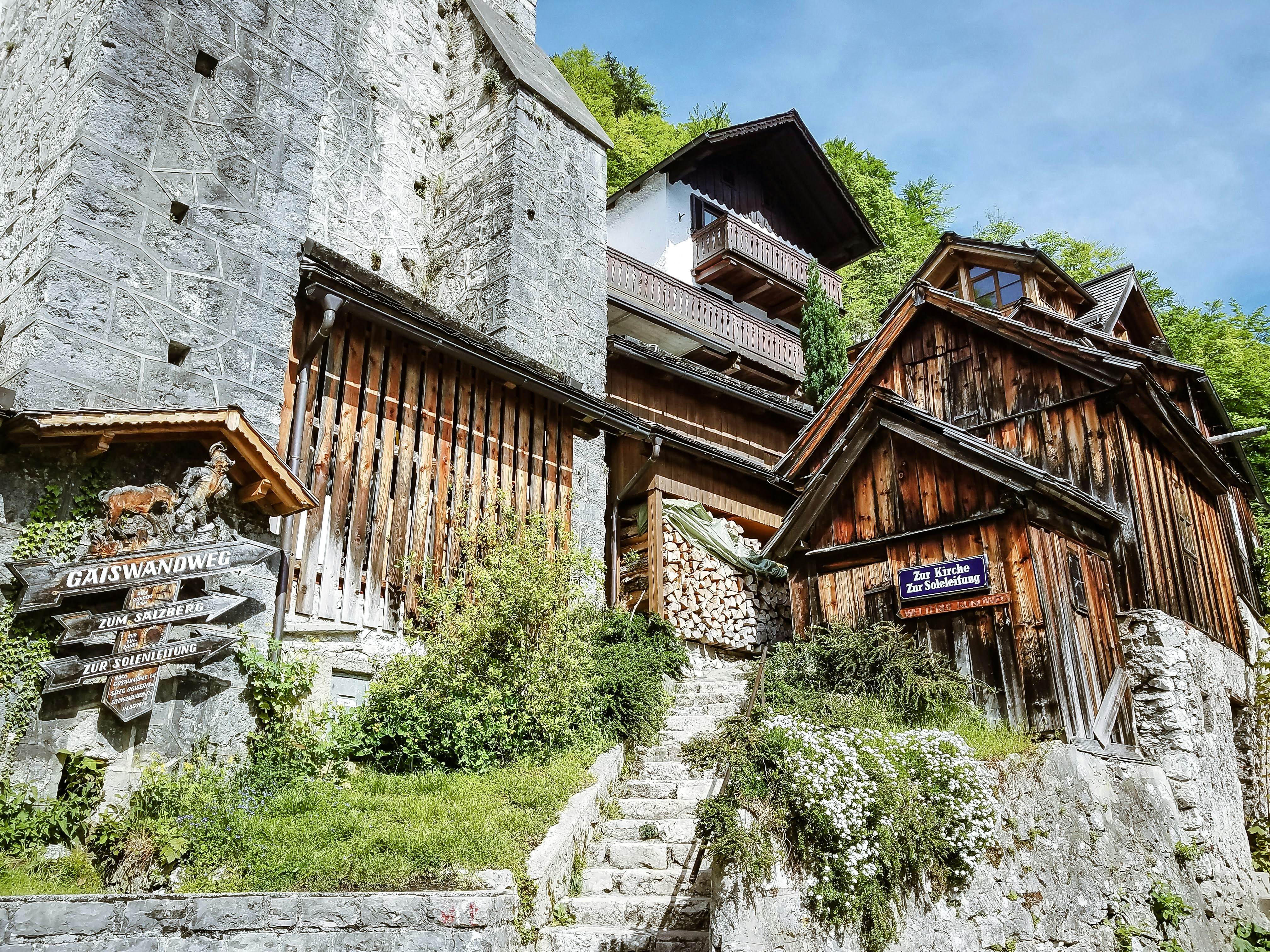 an old wooden building with a sign on the side of it
