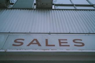 a sign that says sales on the side of a building