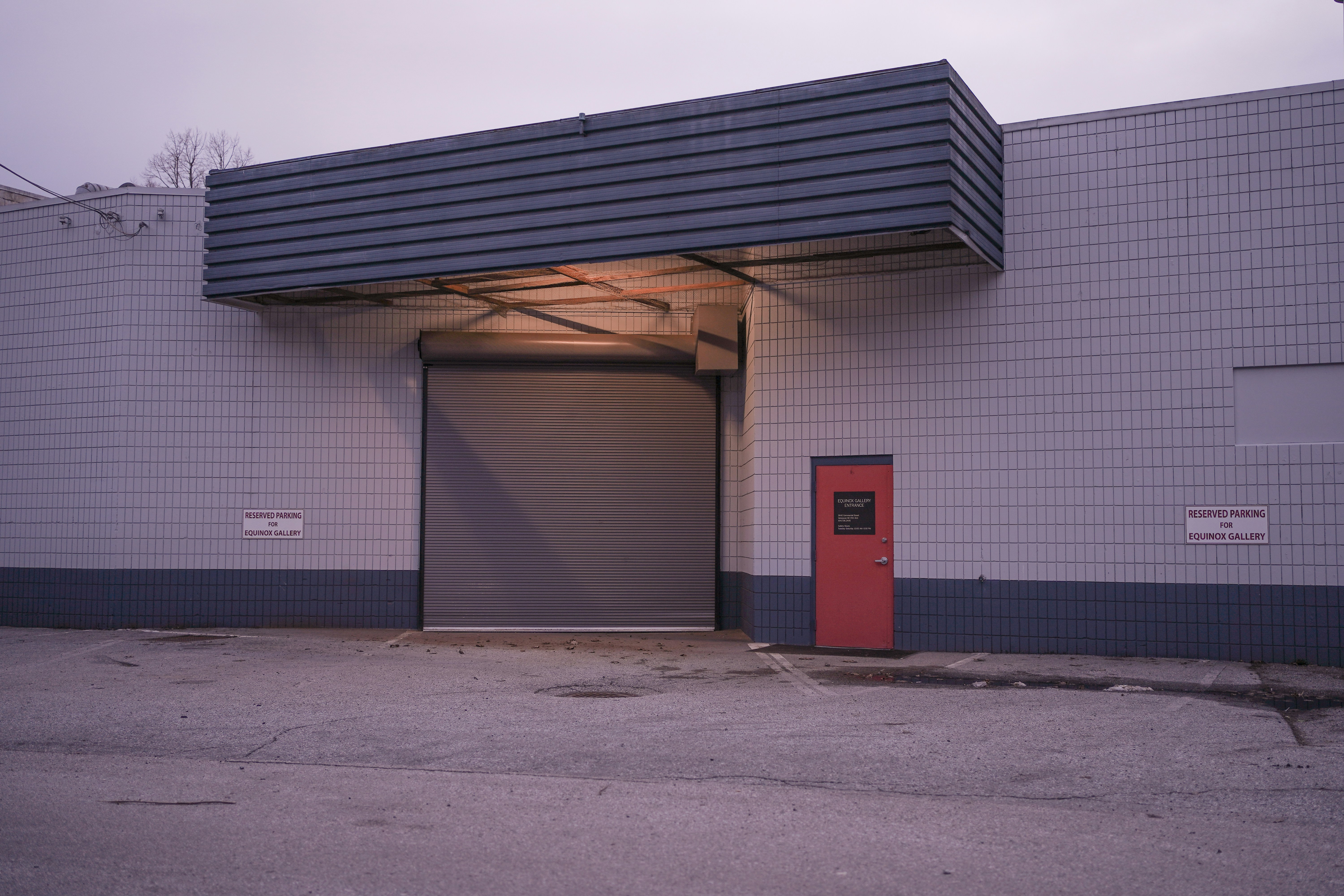 a building with a red door and a red fire hydrant