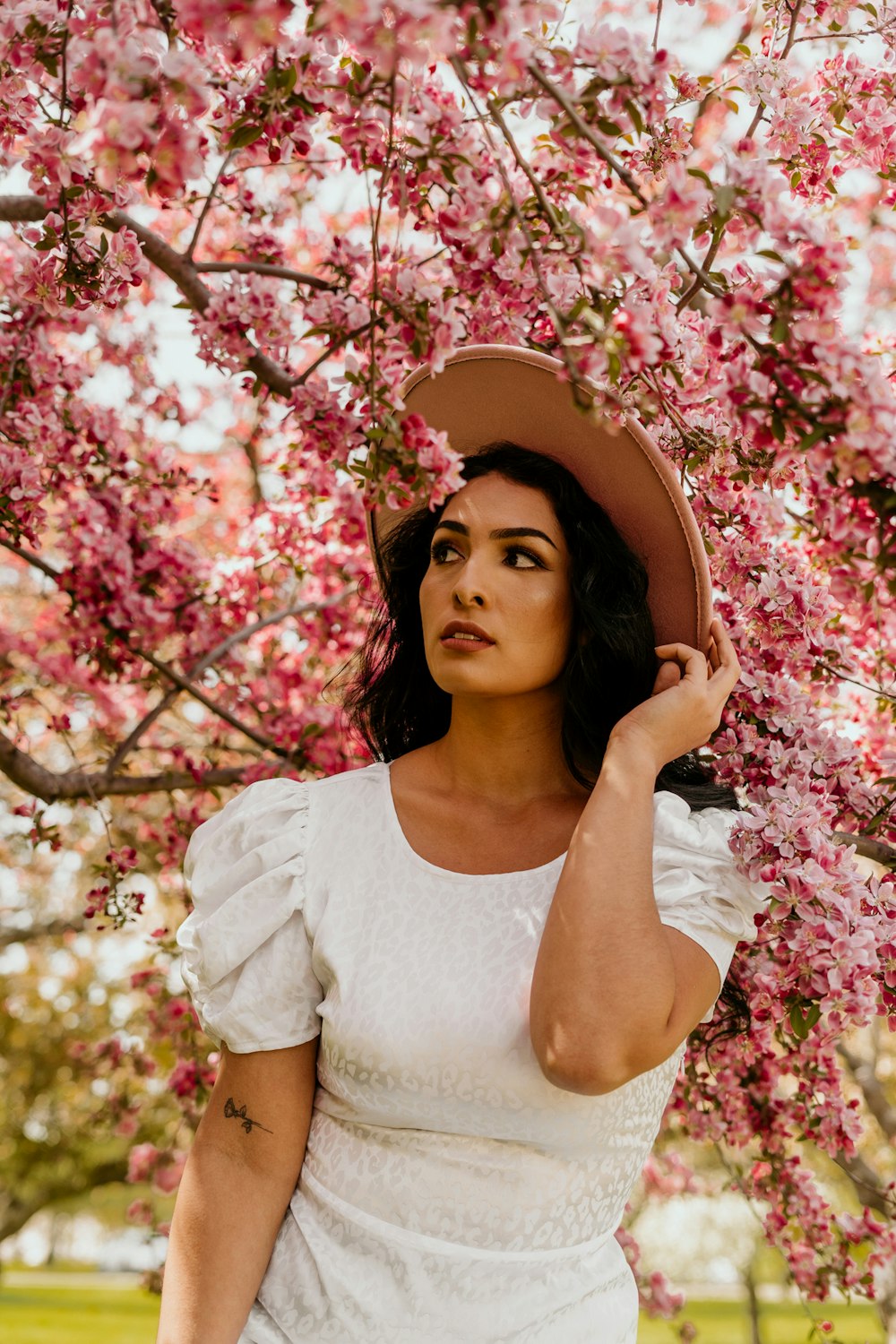 a woman in a white dress and a brown hat