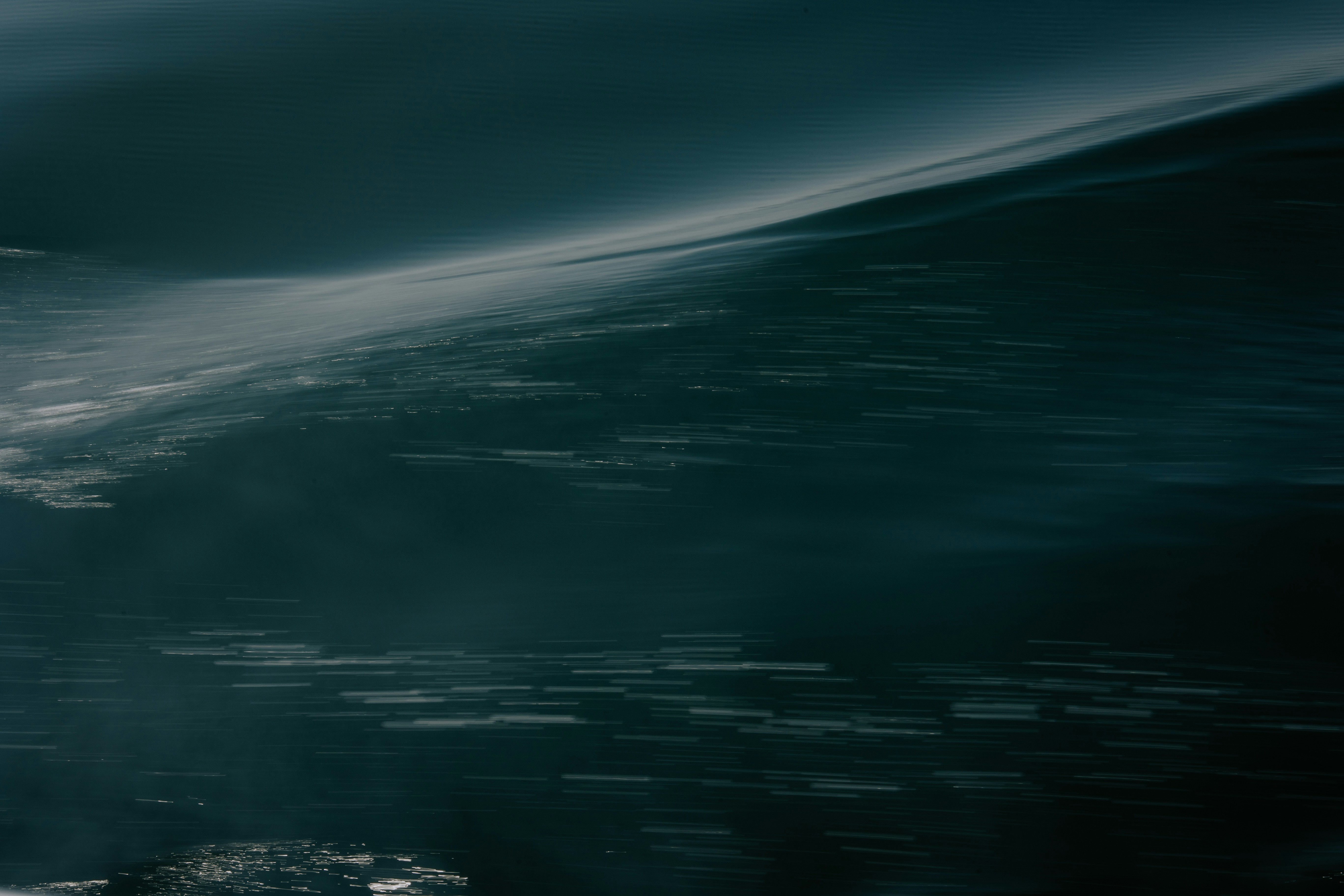 a man riding a wave on top of a surfboard