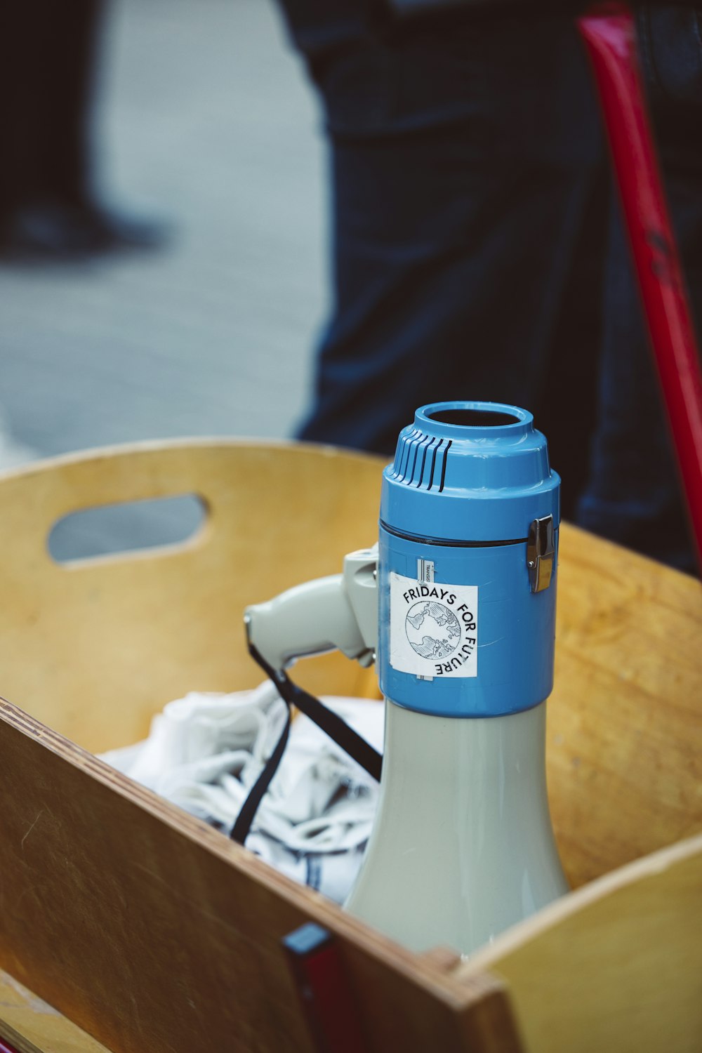 a blue and white water bottle in a wooden box